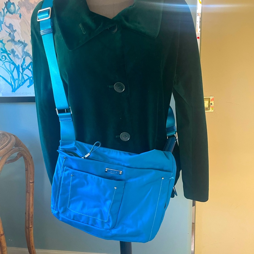 French blue crossbody Tumi bag.